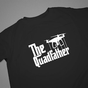 May include: Black t-shirt with a white graphic of a drone and the text "The Quadfather".