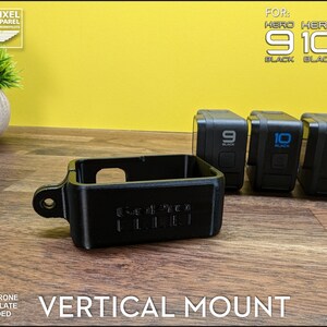 May include: Black vertical mount for GoPro Hero 9, 10, and 11 Black cameras. The mount is made of black plastic and has the text "GoPro" on the side. The image also shows the GoPro cameras.