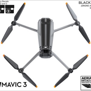 May include: Black decals for a DJI Mavic 3 drone. The decals include a black stripe design on the drone body and numbered decals for the batteries. The text "BLACK DECALS" and "(DRONE AND BATTERIES NOT INCLUDED)" is visible in the image.