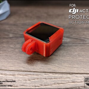 May include: Red 3D printed protector for a DJI Action 2 camera. The protector has a clear screen cover and a mount for attaching to a drone or other equipment.  FOR: DJI ACTION 2 PROTECTOR ACTION MOUNT. Camera, Drone and Baseplate NOT INCLUDED. 3D Printed Protector Only!