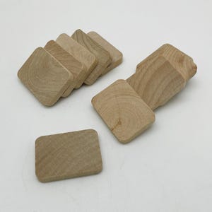 May include: A set of ten unfinished wooden square tiles. The tiles are light brown and have a smooth surface.