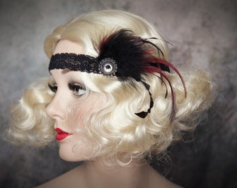 May include: A black lace headband with a decorative embellishment featuring black and burgundy feathers. The headband is adorned with a silver-toned circular centerpiece. The image showcases a vintage-inspired accessory, perfect for themed events or adding a touch of glamour.