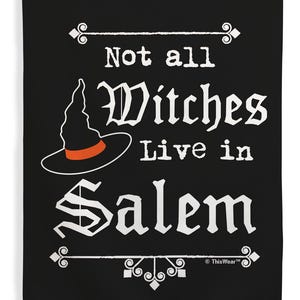 May include: Black flag with white text that reads "Not all Witches Live in Salem." A witch hat with an orange band is featured. Decorative flourishes are at the top and bottom.
