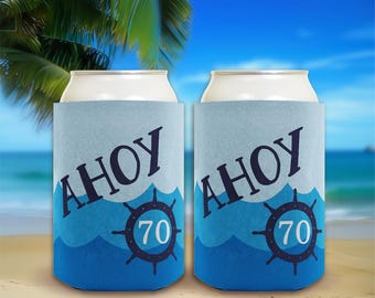 May include: Two blue and white insulated beverage can coolers with the text "Ahoy 70" and a nautical wheel design.