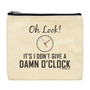 May include: A beige canvas zippered pouch with the text "Oh Look! It's I Don't Give A Damn O'Clock" and a clock face with red and blue hands.