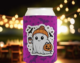 May include: Purple can cooler with a cute cartoon ghost wearing a hat and holding a pumpkin and a cup of coffee. The ghost is white with black eyes and a black mouth. The background is a purple pattern with bats and stars.