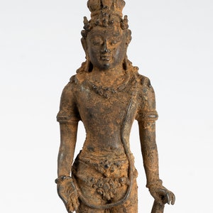 May include: A bronze statue of a standing figure with a crown and a staff. The statue is weathered and has a dark brown patina.