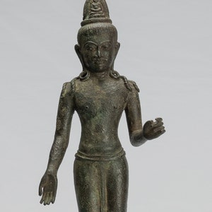 May include: A bronze statue of a standing Buddha figure with a crown and a serene expression. The statue is on a black wooden base.