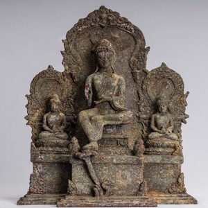 May include: A bronze sculpture of a seated Buddha with two smaller figures on either side. The sculpture is intricately detailed and has a weathered patina.