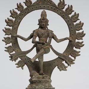 May include: A bronze sculpture of a Hindu deity standing in a dancing pose within a circular frame. The deity has four arms and is adorned with jewellery. The frame is decorated with flames.