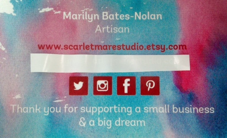 May include: A business card with a watercolor background in shades of pink, blue, and purple. The text on the card reads "Marilyn Bates-Nolan Artisan www.scarletmarestudio.etsy.com" and includes social media icons for Twitter, Instagram, Facebook, and Pinterest. The text at the bottom reads "Thank you for supporting a small business & a big dream."