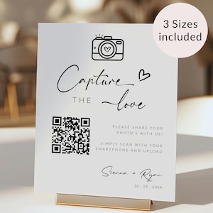 Peut inclure: Une pancarte blanche avec du texte noir et une icône d'appareil photo. Le texte indique "Capture the love" et comprend un code QR. La pancarte comprend également les noms Sienna et Ryan et la date 10-05-20XX.