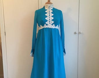 Vintage 1960's deep turquoise maxi evening gown with long sleeves, high neck and white crochet detailing at the neck, bodice and cuffs