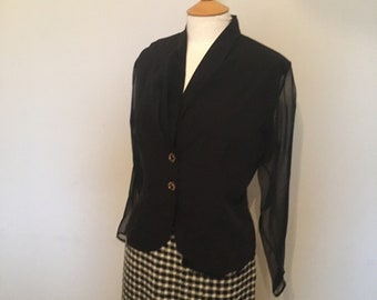 A gorgeous V-Neck 1970s/80s black blouse with chiffon sleeves and 2 front button fastening