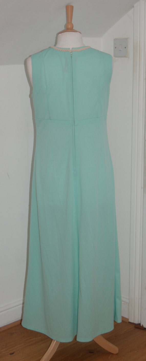 Mint Green Vintage 1960's sleeveless shift dress with cream piping around the collar and long flowing skirt