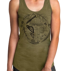 May include: A green tank top with a black and white illustration of a mushroom, leaves, butterflies, and other forest elements.