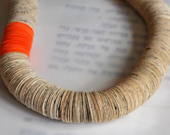 Book paper necklace with an orange touch.