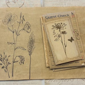 May include: A collection of vintage-style paper ephemera. The image features botanical illustrations, including flowers and wheat, alongside guest check cards. The color palette is primarily sepia tones, creating a rustic and aged aesthetic.