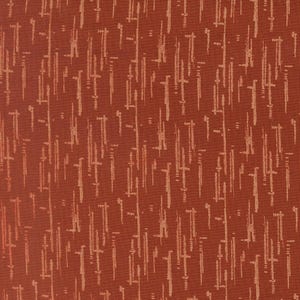 May include: A rust-colored fabric featuring a repeating pattern of vertical, dashed lines in a lighter tan shade. The texture of the woven material is visible, with the light-colored marks creating a rhythmic, linear design across the surface.
