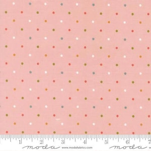 May include: Pink fabric with a repeating pattern of colorful polka dots in white, red, green, yellow, and blue. A ruler is at the bottom of the fabric, with the word "moda" printed on it.