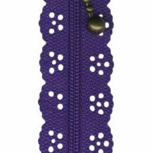 May include: Purple zipper with a decorative lace trim and a bronze zipper pull.