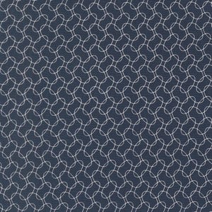 May include: Navy blue fabric with a repeating pattern of white interlocking circles. The design creates a textured, geometric effect across the surface. The fabric appears to be a medium weight, suitable for various sewing projects.