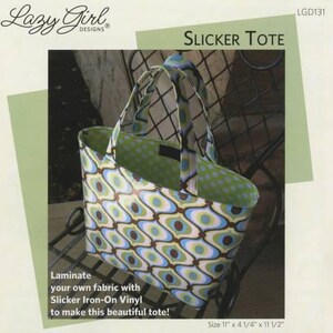 May include: A green and white tote bag with a geometric pattern. The bag is made with Slicker Iron-On Vinyl and is 11 inches wide, 4 1/4 inches deep, and 11 1/2 inches tall.  The bag is sitting on a black metal chair.
