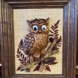 Rare Owl artwork made from pinecones and wood.  canvas or burlap background, leaves and twigs 3d.