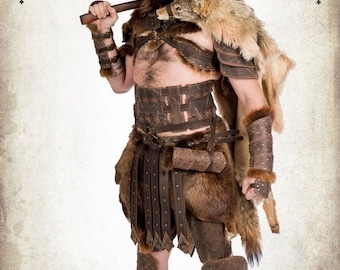 May include: A person wearing a leather and fur costume with a large axe. The costume includes a fur-lined leather tunic, leather bracers, and leather leggings. The person has a painted face and is holding the axe in their right hand.