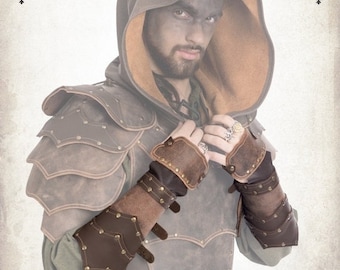 May include: Brown leather armor with a hooded cloak and studded leather bracers. The armor has a distressed look and is decorated with metal rivets. The word "Dracolitte" is written in a decorative font at the top of the image.