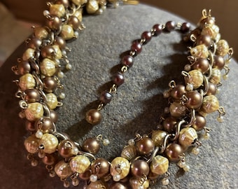 Unusual Beaded cha cha necklace. 1970 Coppertone and cream