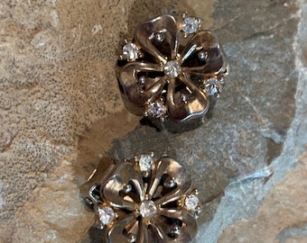 Trifari clear rhinestone and gold tone four petal flower design