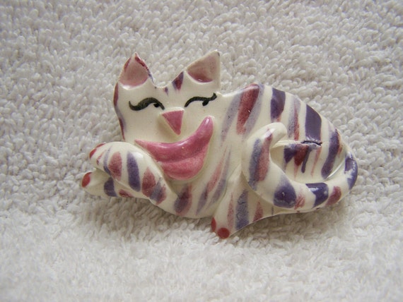 White pottery cat with an abstract design is pain… - image 1