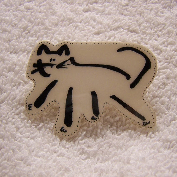 Calligraphy sketched cat is cut out of art paper and laminated. Vintage brooch by The Wendelline.