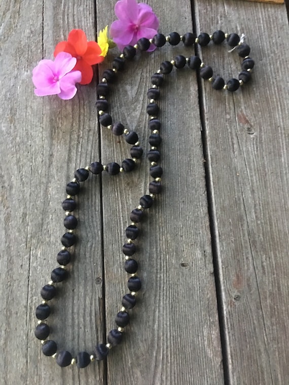 An elegant mid century Asian Imported black silk beaded necklace With goldtone Spaces very pretty Sexy