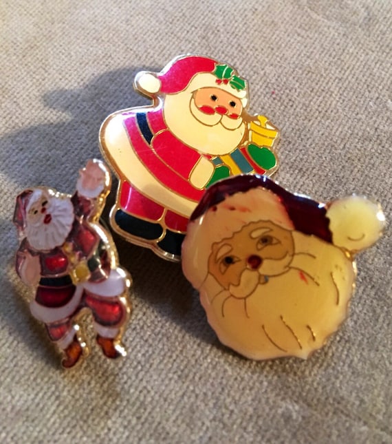 Three vintage enamel finished Christmas Santa  pins wear them togther or festively apart