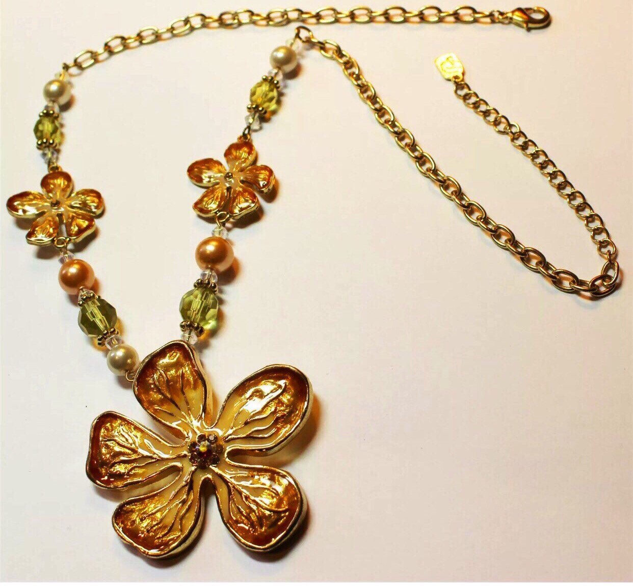 Peachy golden enameled flowers accented with crystals & pearlized beads ...