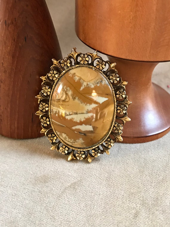 Funky 70s Mash Up of Tiny dainty Goldtone flowers Framing a Large Bold Polished Stone Cabochon A Marvelous Mid Century Unisex Lapel Pin