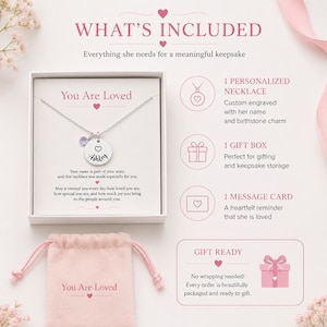 May include: A silver necklace with a personalized pendant and a purple gemstone, presented in a gift box with a message card. The text on the pendant says "Ashley". The image also includes a pink gift bag that says "You Are Loved".