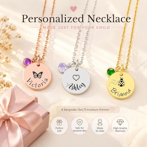 May include: Three personalized necklaces with round pendants. One is rose gold with a butterfly and the name "Victoria", another is silver with a heart and the name "Ashley", and the third is gold with a ladybug and the name "Brianna". Each necklace has a gemstone.
