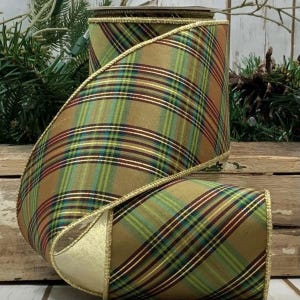 May include: A roll of 2.5 inch wide plaid ribbon with a gold wired edge. The ribbon features a brown, green, and red plaid pattern.