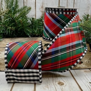 May include: Red, green, and blue plaid ribbon with a black and white gingham trim. The ribbon is rolled up and tied in a bow.