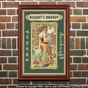 May include: Framed vintage art print featuring "Bisquit's Brandy." The artwork depicts a woman in a flowing gown holding a glass, surrounded by foliage. The print has text in multiple languages and is set against a green background.