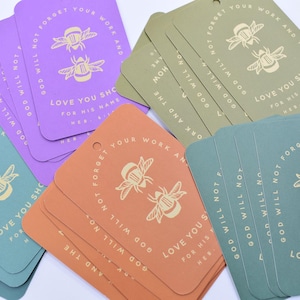 May include: A stack of colorful gift tags with a bee design and the text "Do not forget your work and the love you show for His name. Heb. 6:10".