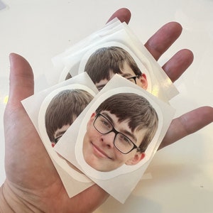 Waterproof vinyl face stickers with glossy finish.