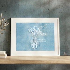 May include: A framed print featuring a light blue background with a white, ethereal illustration of a human brain connected to a heart. The text "HEART-BRAIN COHERENCE" is printed in white capital letters to the right of the central illustration.