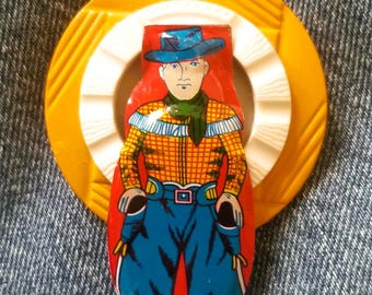 Original Brooch Out of Tin Cowboy Clicker on Plastic Buckles