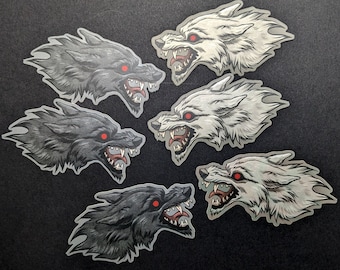 Snarling black and white wolves sticker pair