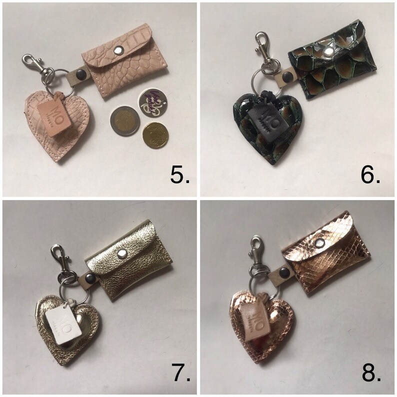 May include: Four keychains labeled 5, 6, 7, and 8, each featuring a small rectangular pouch with a snap closure and a heart-shaped charm. The pouches and hearts have varied textures and metallic or matte finishes in pink, green, gold, and bronze.