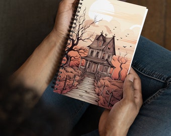 May include: Spiral-bound notebook featuring a spooky haunted house illustration. The artwork depicts a detailed, multi-story house with a long wooden walkway leading to the front door. The color palette includes shades of orange, brown, and gray, with a full moon in the background.